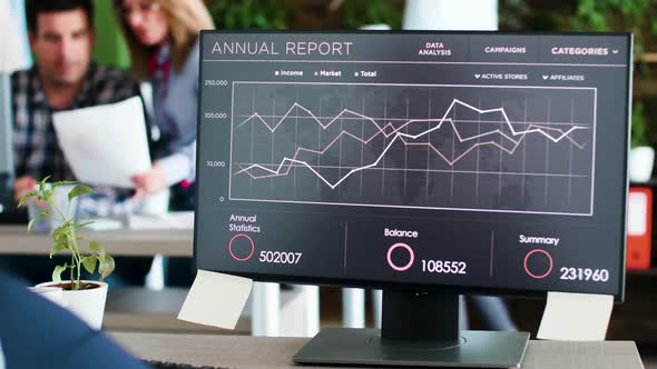 Beautiful Young Business Woman Working on Graphics on Her Monitor alt