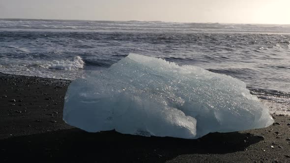Iceland Jokulsarlon Black Sand Diamond Beach With Iceberg Ice Chunks On Ocean Shoreline