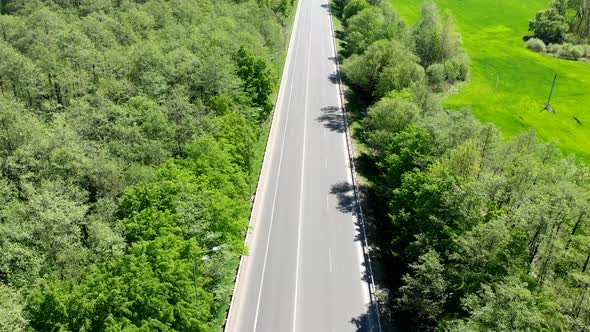 Empty Road Without Cars. The Highway Goes Through Fields and Forests Without Passing Cars.