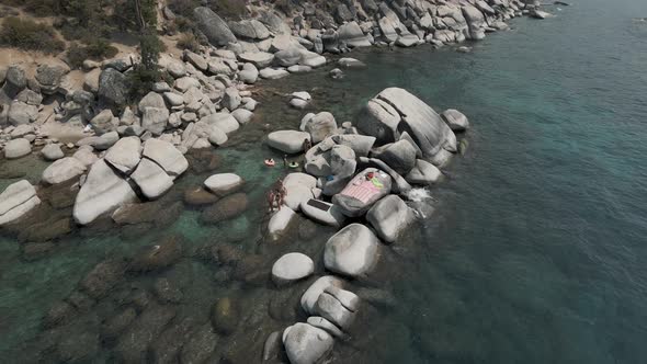 Beautiful ladies relaxing on the rocks alt