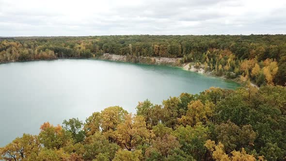 Wild forest and lake. Aerial view of blue lake and green forests alt