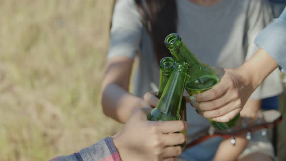 Close up hands group of a young teen Asian celebration beer cheers and clinking glasses.