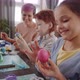 Little Girl Applying Paint to Easter Egg with Finger