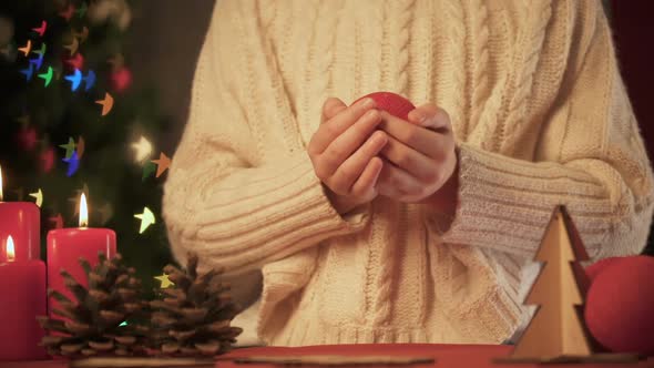 Little Girl Holding Ball, Mom Cupping Her Hands Tenderly, Belief in Happy Future alt