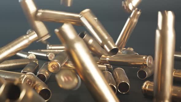 Empty shells falling down on the floor. Gun ammunition. Metal bullets. Ammo. alt