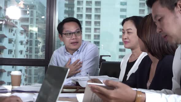 Asian Business People Discuss Marketing Strategy alt