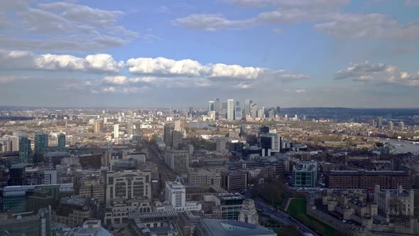 Aerial panning shot showing London Canary Wharf Cityscape with high rising buildings and River Thame alt