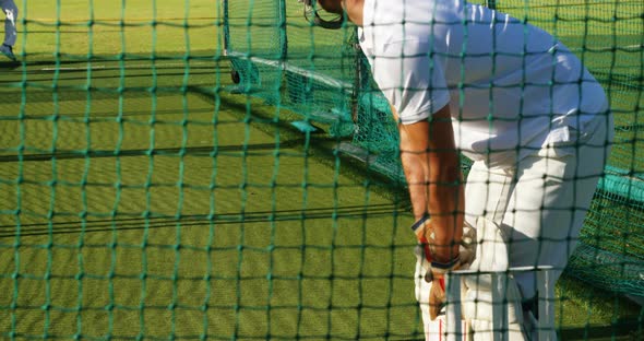 Cricket players practicing in the nets during a practice session alt