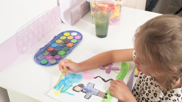 Talented Creative Child Girl Female Artist Draws with Her Hands on Paper Using Fingers Paints Brush