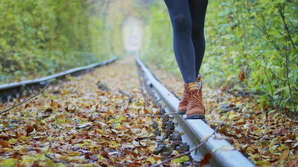 Happy Young Female Tourist Spinning in the Tunnel of Love with Autumn Leaves Breathing Fresh Air alt