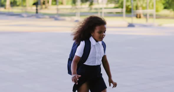 Schoolgirl with a Backpack Runs to School alt
