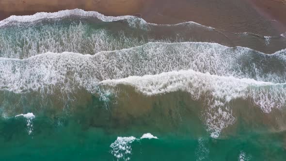 Aerial View of the Mediterranean Coast Waves Reach the Deserted Sandy Beach alt