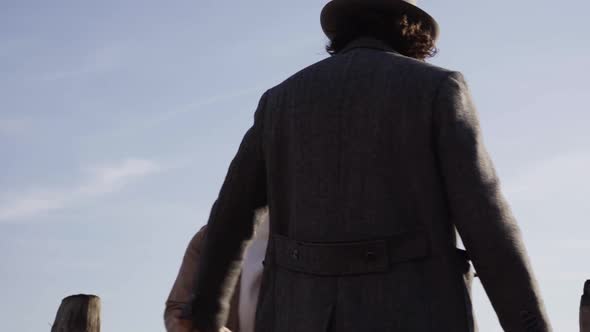Slow motion shot of young couple on a pier in Venice alt