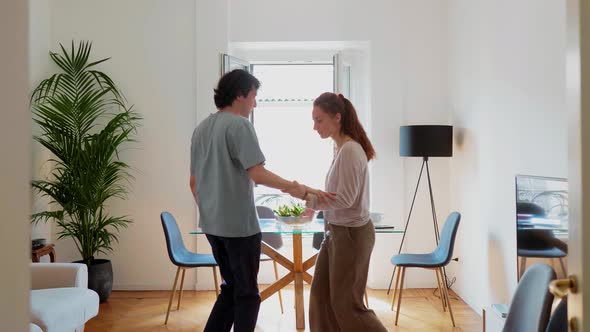 Couple dancing in living room alt