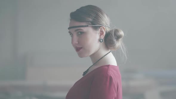 Portrait of a Successful Girl in a Red Dress Confidently Looking Into the Camera. Young Woman in an alt