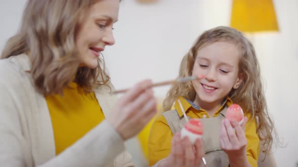 Happy Woman and Girls Decorating Easter Eggs alt