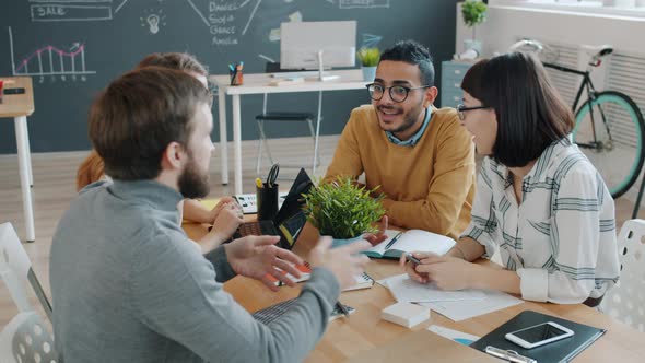 Male and Female Coworkers Doing High-five Sharing Ideas Working Together in Office alt