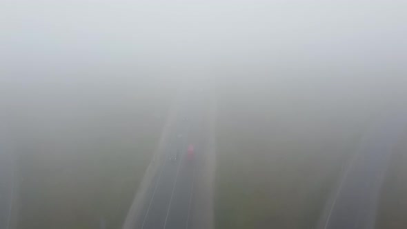 Strong Fog on the Road Aerial Drone View