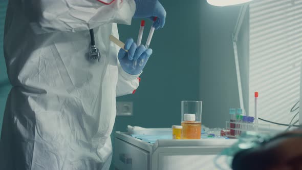 Doctor Testing Covid19 Patient for Virus in Hospital Infectious Unit Closeup alt