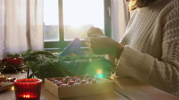 Woman Making Fir Christmas Wreath at Home