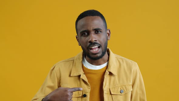 Portrait of AfroAmerican Guy Pointing at Himself Then Crossing Arms Showing No Gesture Shaking Head alt