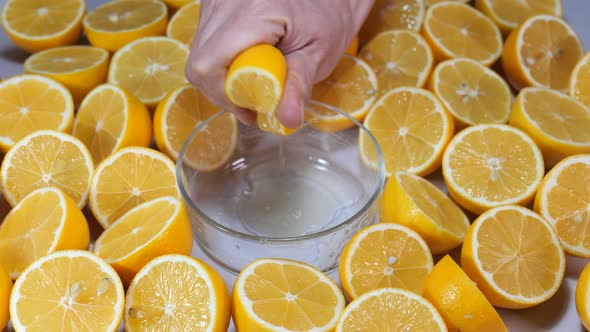 Woman squeezing fresh lemons