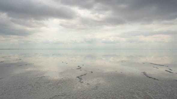 Clouds reflected in the smooth water of the salt lake.