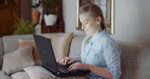 Smiling Woman Working on Laptop at Home Office. Businesswoman Typing on Computer Keyboar. alt