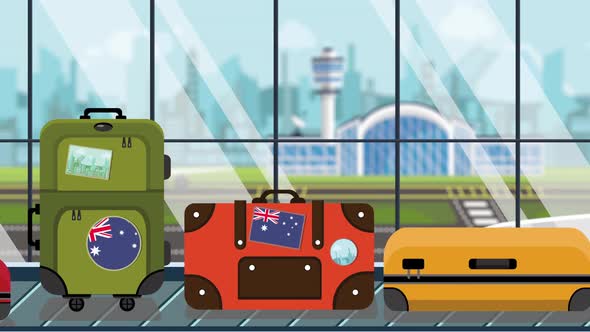 Baggage with Australian Flag Stickers on Carousel in Airport alt