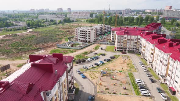 Aerial View of a Modern Apartment Building with a Red Roof alt