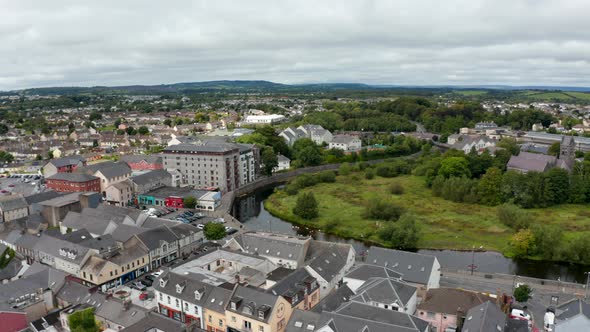 Slide and Pan Aerial Shot of Buildings in Town alt
