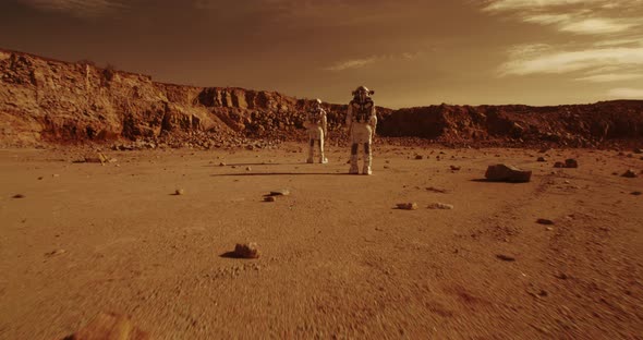 Unrecognizable Astronauts Standing Against Mountains on Mars alt