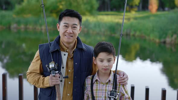 Portrait of the Happy Asian Family is Going to Fishing Standing on the Pier Together alt