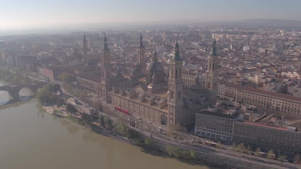 Aerial of the Basilica and buildings along the riverside alt