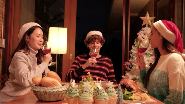 Family and friends a Christmas celebrating in home's dining room. alt