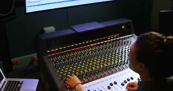 Male audio engineer using sound mixer alt
