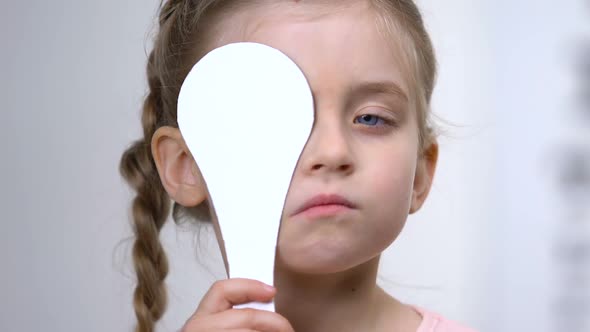Cute Girl Covering Eye, Vision Check in Clinic, Ophthalmological Test, Eyesight alt