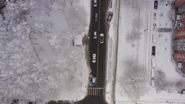 A Taxi Car Drives Through the Snowcovered Streets of the City After a Snowfall