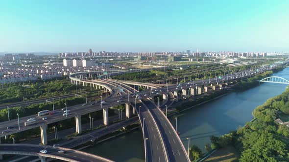 Aerial Drone View of Highway Multi-level Junction Road with Moving Car at Sunset. Active Movement of alt