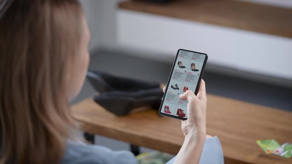 A Woman Is Engaged in Online Shopping While Sitting on the Couch alt