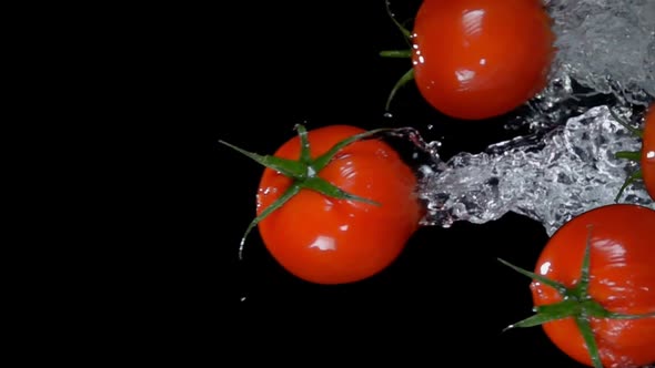 Small Cherry Tomatoes are Bouncing Horizontally on the Black Background ...