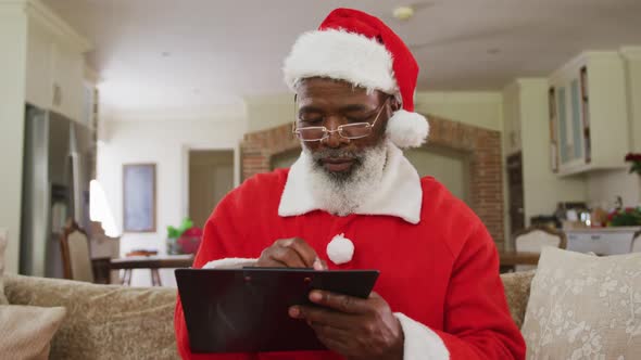 Senior african american man wearing santa costume at christmas time alt