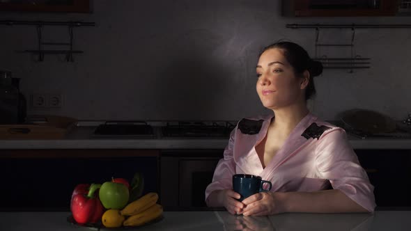 Girl Enjoys Morning Drinking Fragrant Coffee at Darkness alt