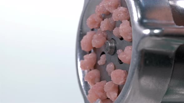 Pieces of Meat Come Out Through the Holes in the Meat Grinder When It Is Scrolled alt