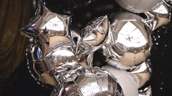 Mirror Inflatable Helium Balloons Resembling Stars at a Holiday