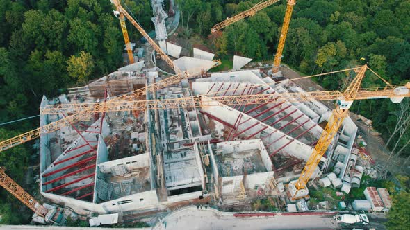 Aerial View Construction of a New Building with High Tower Cranes in Green Area alt