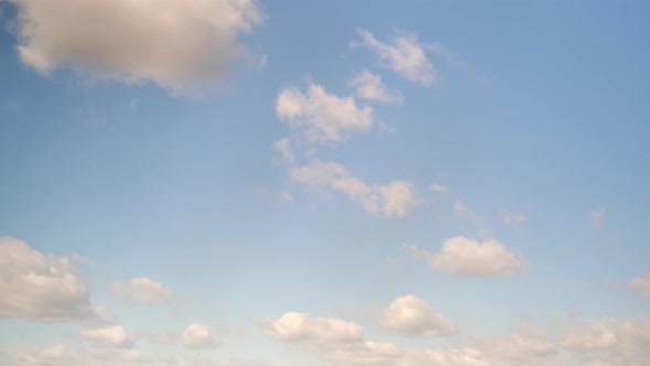 White cumulus clouds in the blue sky, timelapse. Bright beautiful sky, copy space background