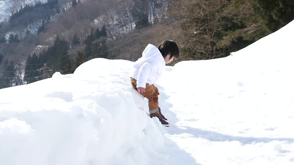 Cute Asian Child Playing Snow Outdoors Slow Motion alt