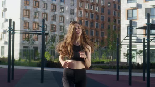 Slender Young Brownhaired in Sport Clothes in Morning Makes Run on Spot alt