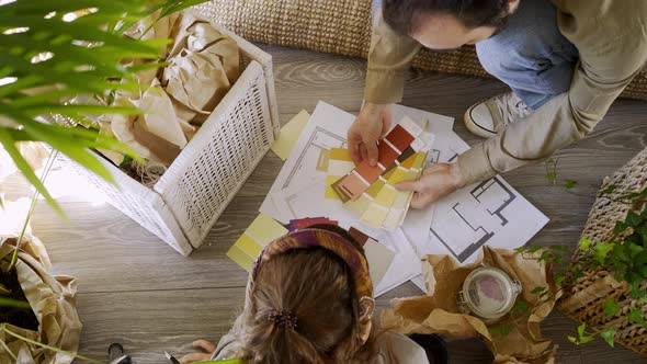 Woman and Husband with Palette and Drawing Choose Decoration